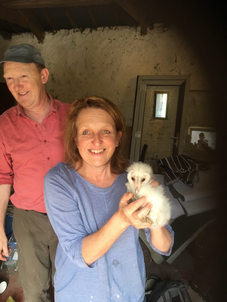 Your hosts Liz and Martin with a baby barn owl